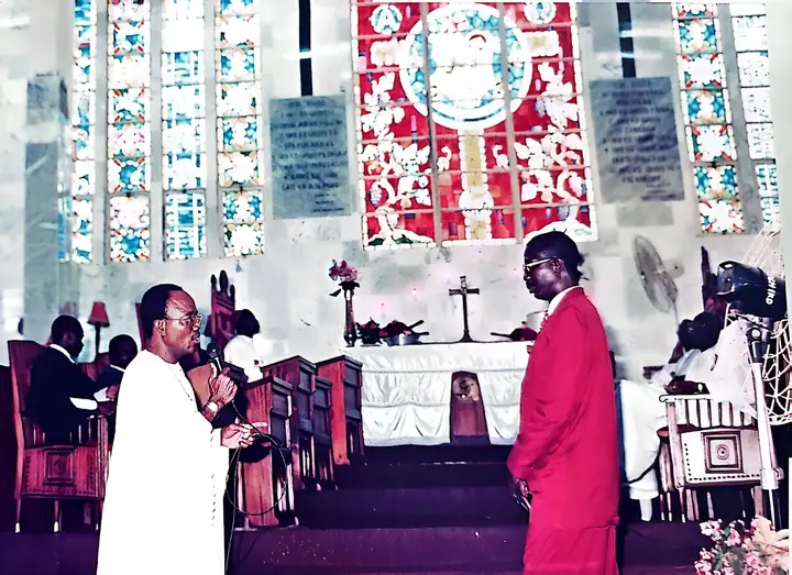 People gathered in front of the stained-glass windows during a church service